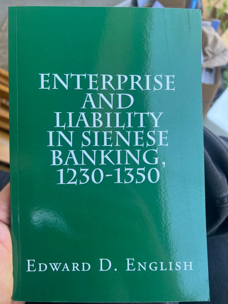 Holding green book that simply says enterprise and liability in Sienese banking 1230 through 1350 by Edward D English