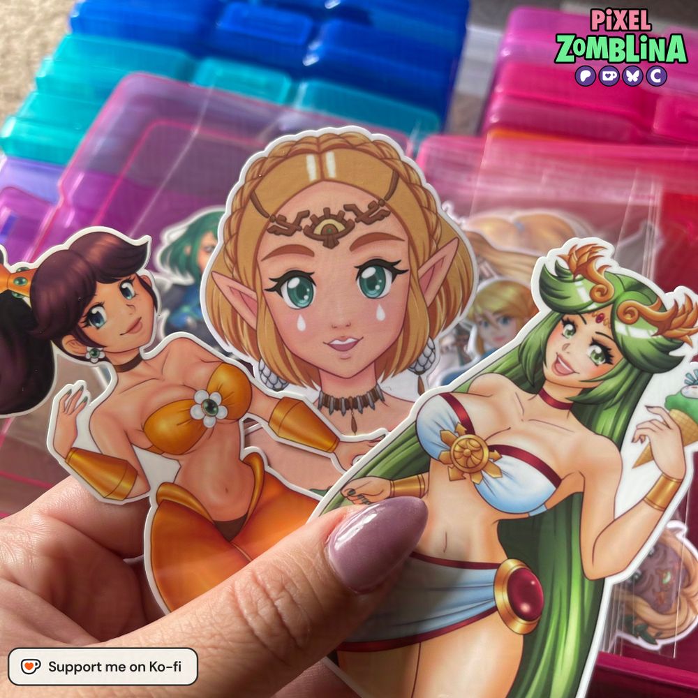 Me holding onto three stickers. From right to left: Princess Daisy in her own genie outfit, Princess Zelda in the middle with her TOTK Gown, and Palutena in her own swimsuit on the right. She is holding ice cream. Barely visible in the back in Sky Blue Pyra, Samus, and Queen Sonia.