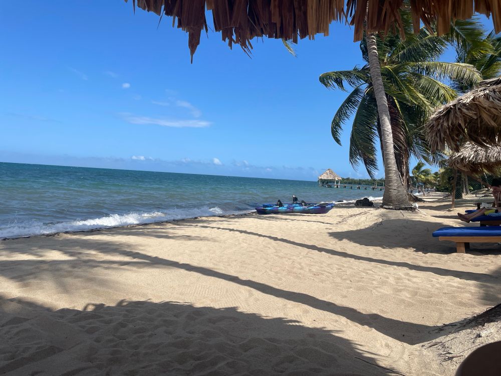 Beach in Belize with kayaks pulled up on the sand