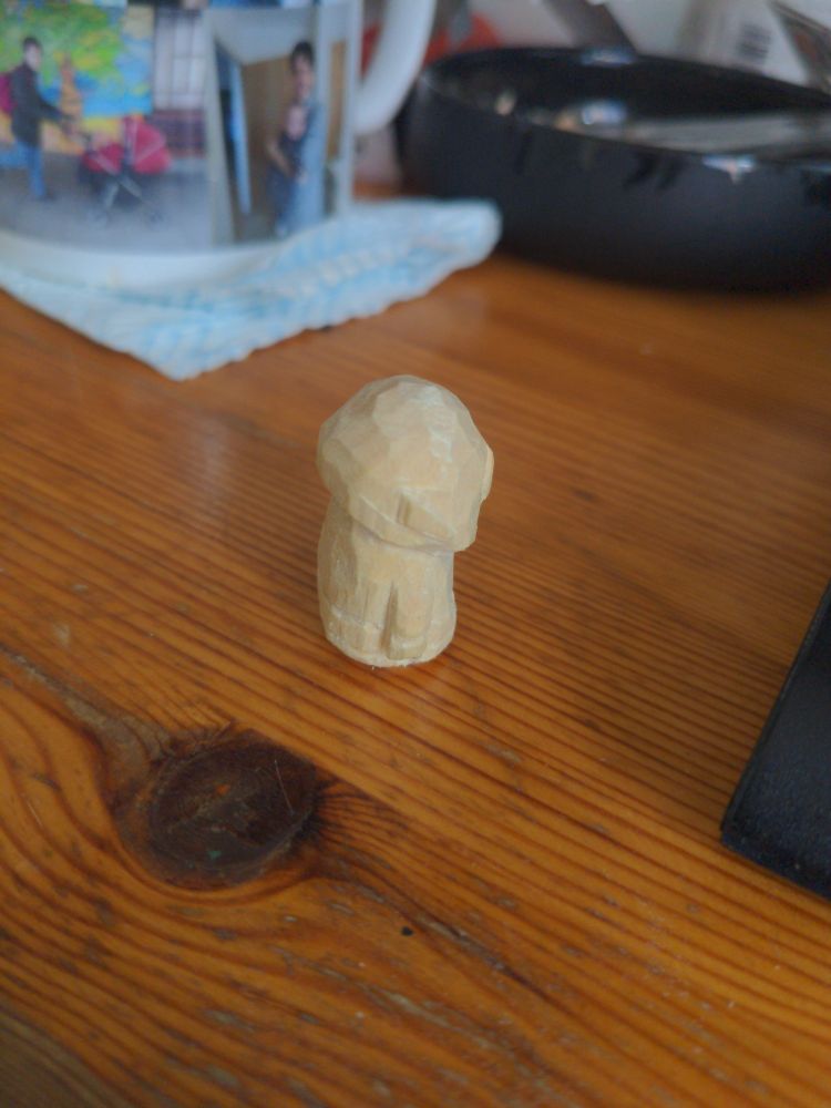 A very amateurish carved wooden goblin, side view