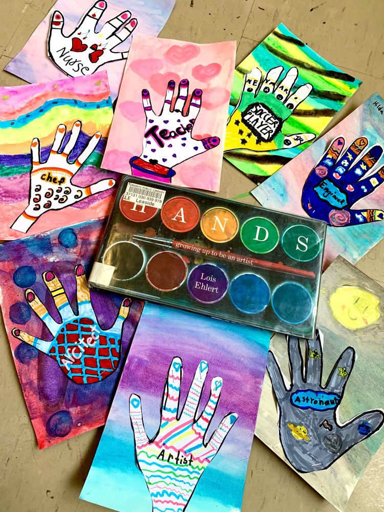 Colourful student artwork of their hands with designs and watercolour backgrounds