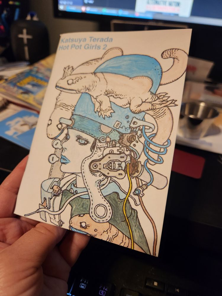 Cover of a small booklet, 4 x 6 inches; the title is Katsuya Terada, Hot Pot Girls 2. The illustration, black and white with some parts colored in blue, is a girl from the shoulders up, wearing a complicated helmet-like contraption; amphibious creatures float around her head. 