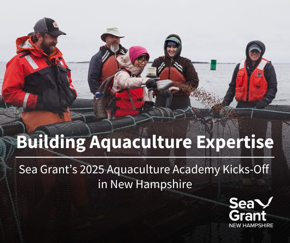 A group of Aquaculture Academy participants gather around on the AquaFort's floating platform while tossing fish feed into a fish pen. The group is wearing bright orange lifejackets, and smiling. 