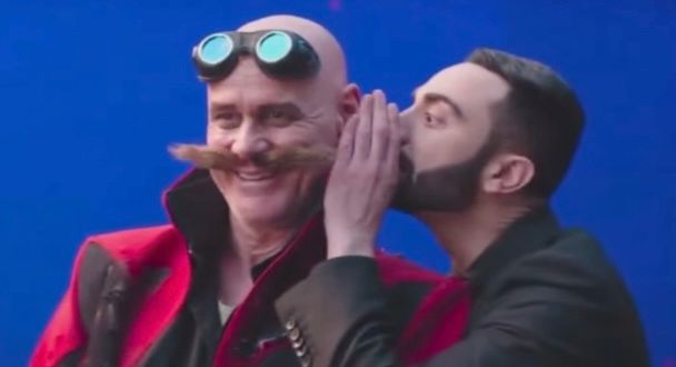 Original screenshot from Sonic 3 deleted scenes. In which Agent Stone (played by Lee Majdoub) whispers something in Dr. Robotnik’s ear (played by Jim Carrey). 
