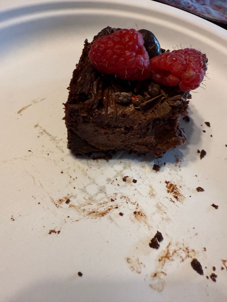 Picture of the side view of a bite of the cheesecake to show off the texture. 