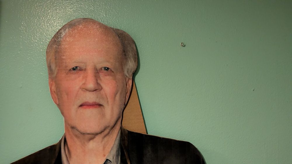 The head and shoulders of a life-sized Werner Herzog standee.