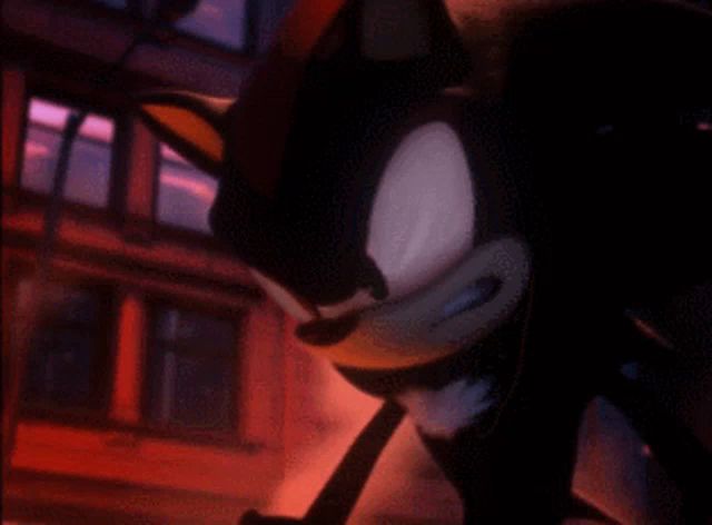 a close up of shadow the hedgehog 's face with a blue background