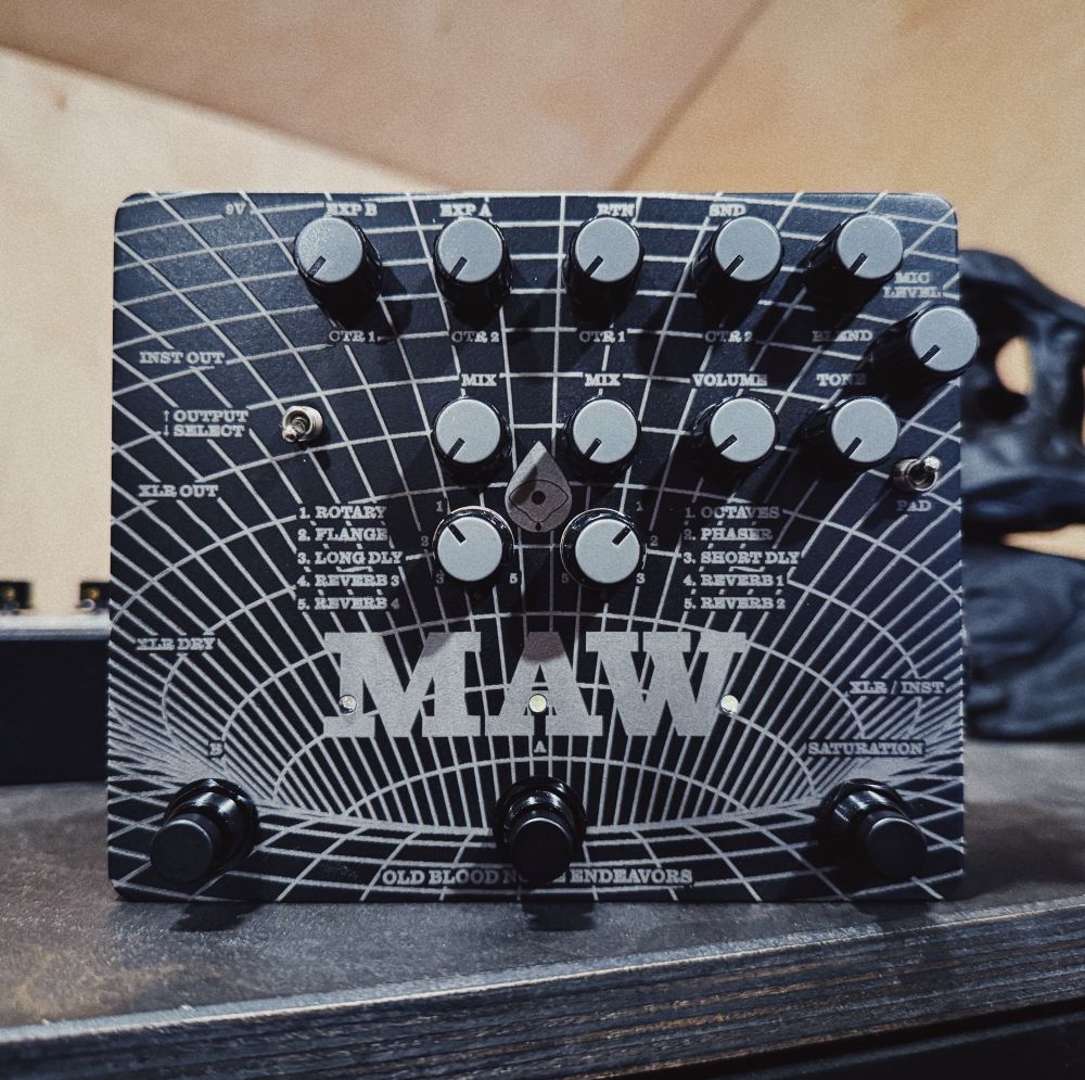 Black guitar pedal called MAW with laser engraved artwork