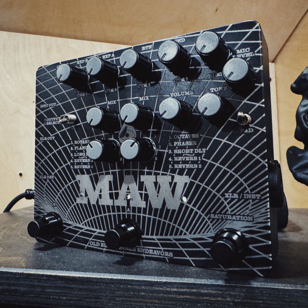 Black guitar pedal called MAW with laser engraved artwork
