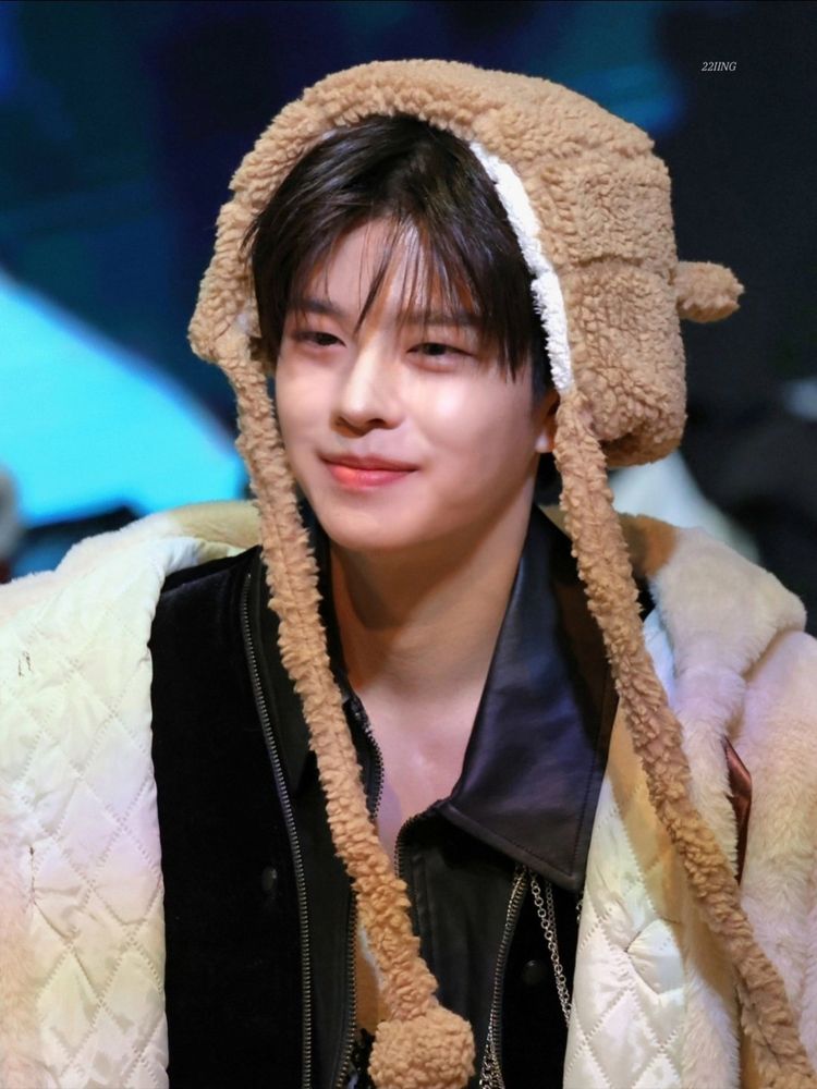 stray kids seungmin in a fluffy hat, smiling and looking very adorable 