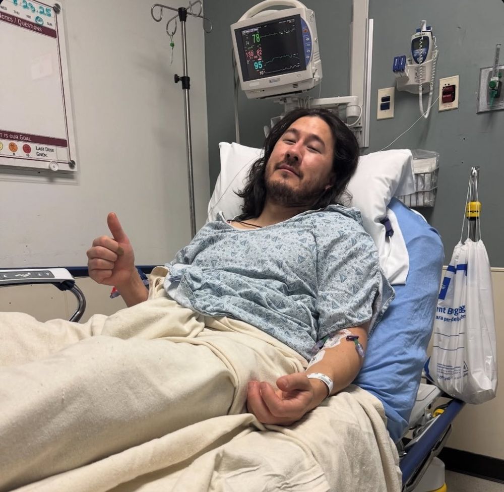 Internet personality Markiplier in a hospital bed giving the camera a thumbs up 