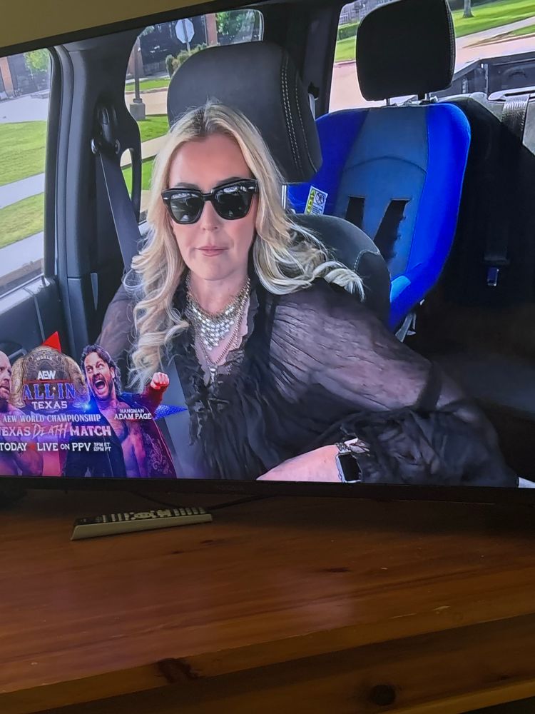 Renee Paquette discussing her husbands match with Adam Page in his car with Wheeler Yutas car seat in the back seat 