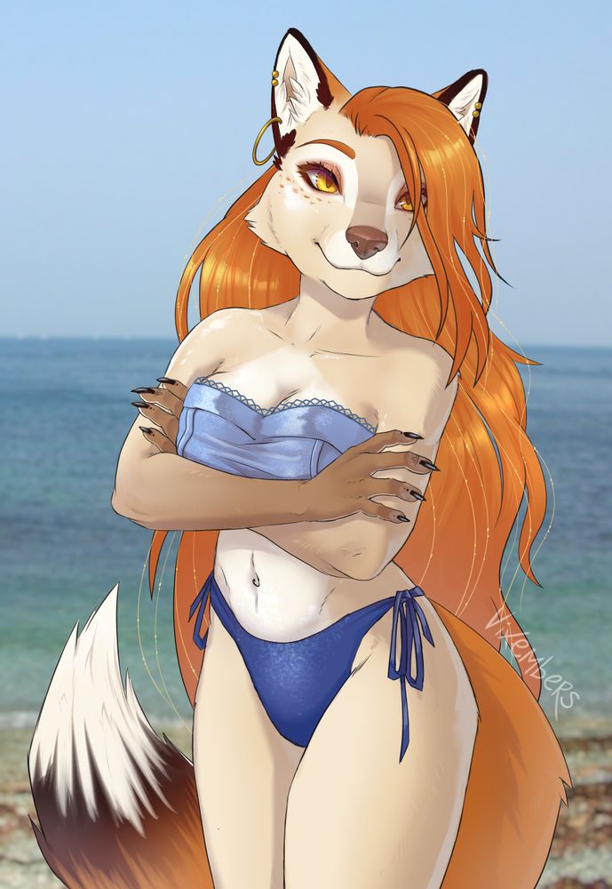 A tan-coloured vixen with long ginger hair and amber eyes stands with arms comfortably crossed, apparently satisfied with the bright weather. She wears a shimmery blue bikini and simple gold jewellery. There's a stony beach with the ocean and a cloudless blue sky in the background