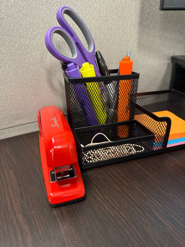 Desk set up with a red stapler. 