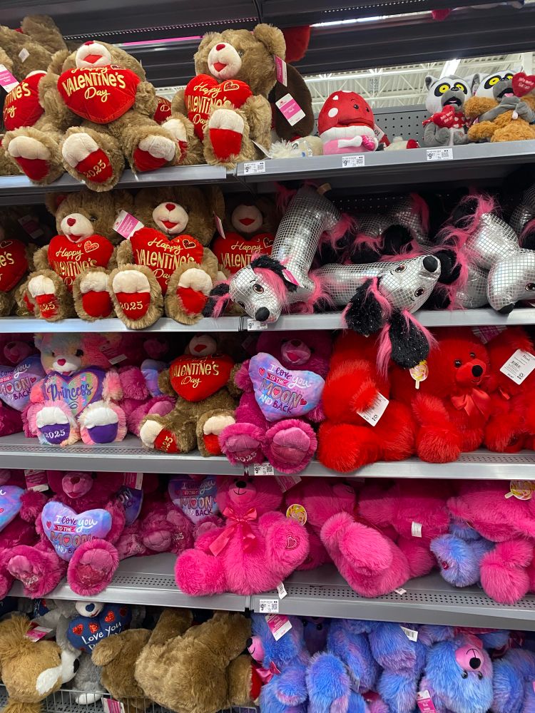 Plush bears on a shelf along with disco dogs.