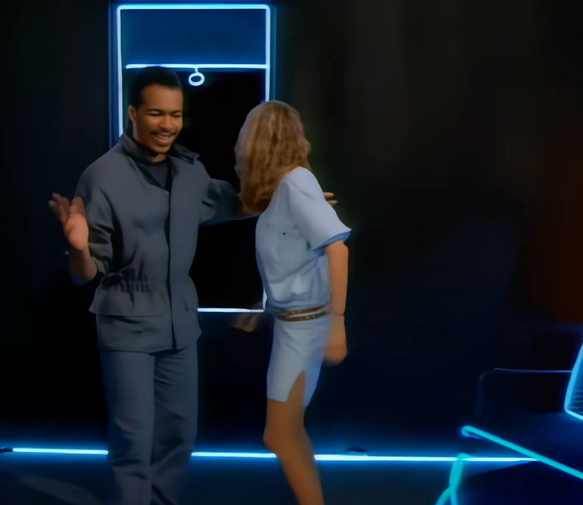 AI filter on a screencap from the Ray Parker Jr music video for Ghostbusters, shows figures with incredibly smoothed out features dancing in in a black void with stylised lighting around window silhouettes.