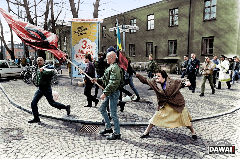 Famous black and white picture from Sweden showing a middel aged woman angrily bashing a nazi skinhead with her handbag. 