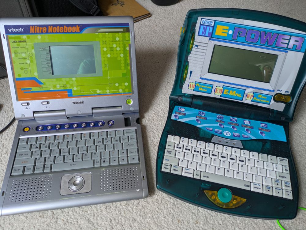 A pair of VTech childrens laptop toys