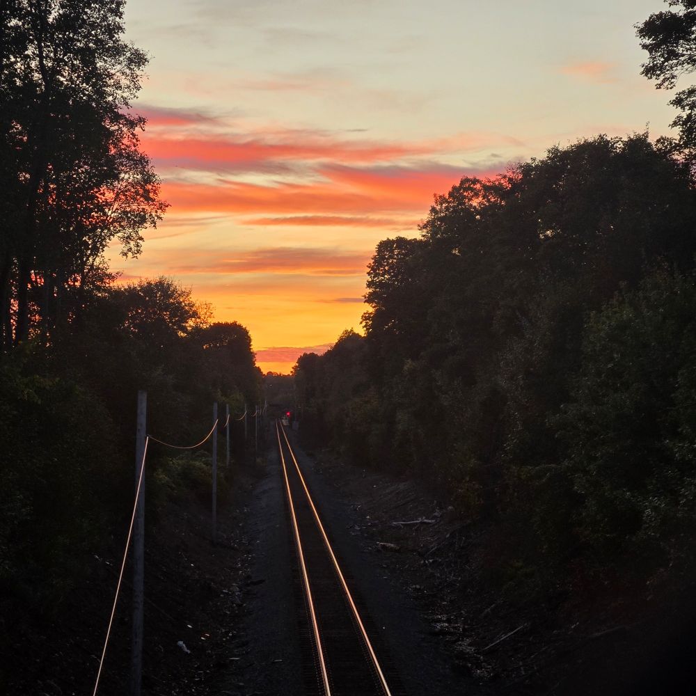 Saturday sunset highlights the railroad tracks in Roslindale Massachusetts 
