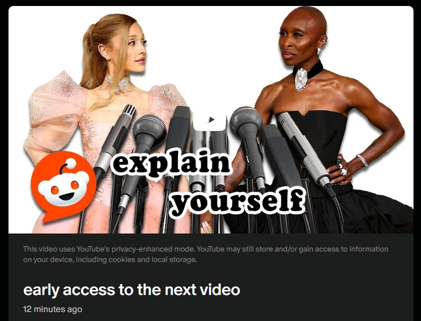 thumbnail on patreon that shows Ariana Grande and Cynthia Erivo holding hands with microphones in front of them. the text reads 'explain yourself' with a reddit logo on the bottom left corner