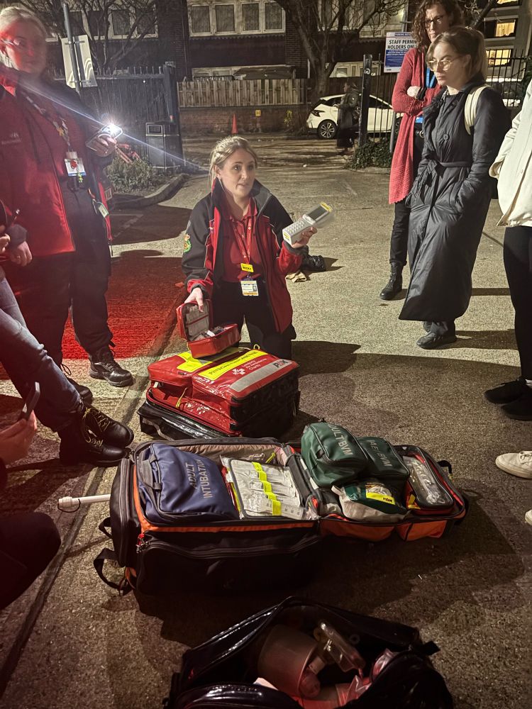 An ambulance doctor demonstrating the medical equipment in a response car.