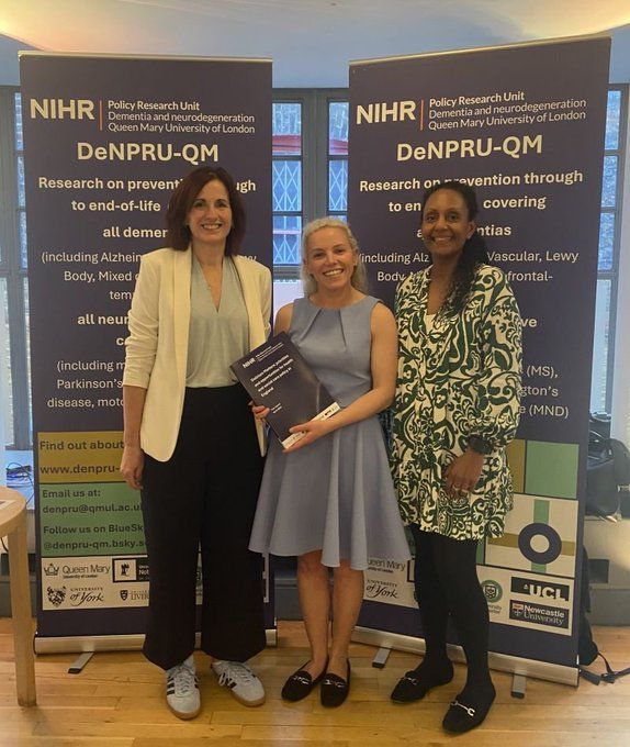 Three people holding a copy of the delirium matters policy report