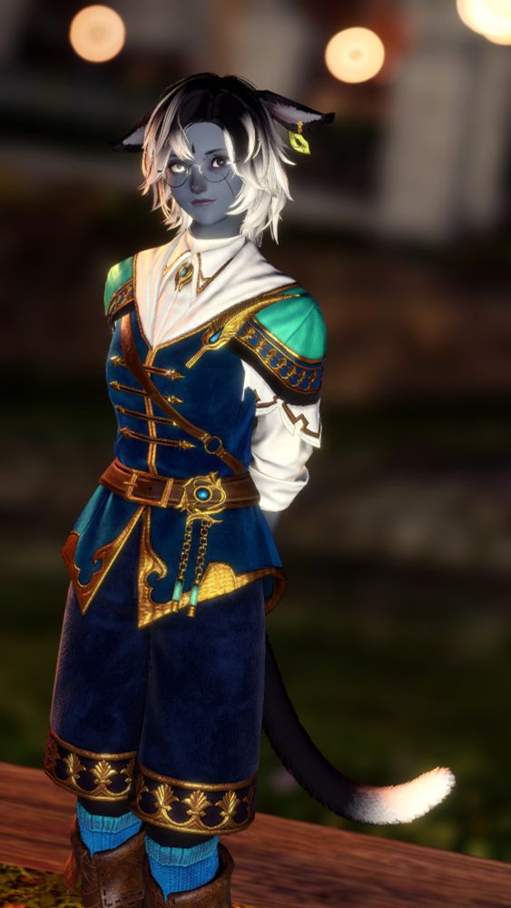 Miah standing with her hands behind her back, dressed in ornate crafter gear without its usual feathers or bag. She is smiling at the camera.