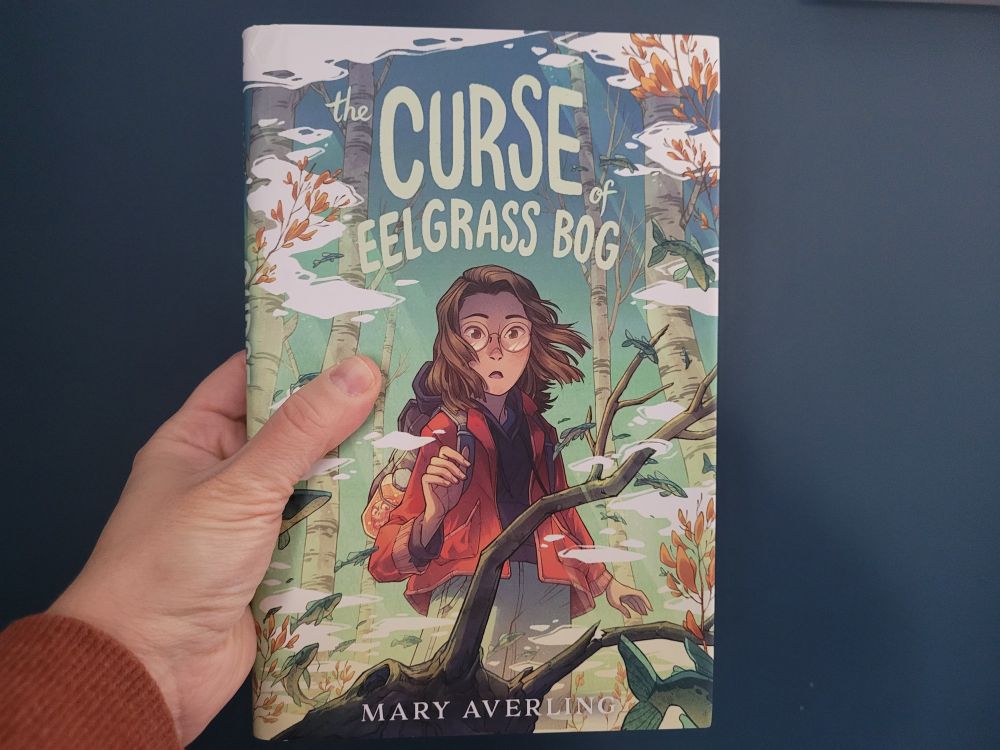 Cover of The Curse of Eelgrass Bog, showing a windblown girl with light skin and glasses appearing to approach some suspicious-looking branches.