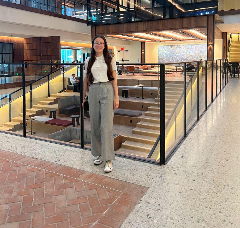 Kaylee May Law standing in the lobby of the Hopkins Bloomberg Center.