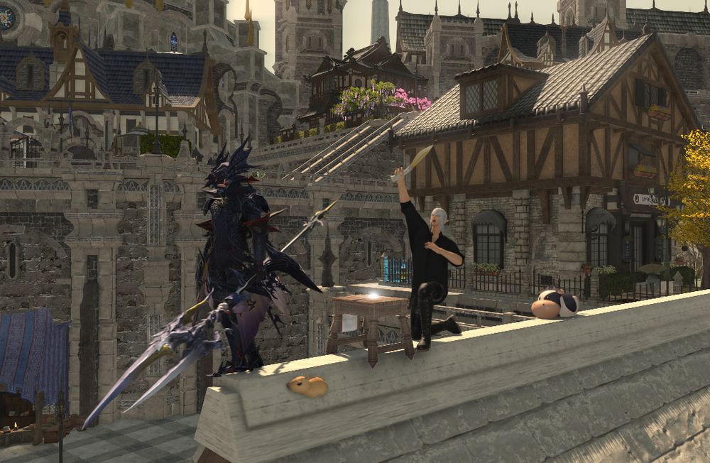Meteor the Warrior of Light is in his Heavensward Dragoon armor standing idly on top of a roof. Behind him, Estinien is raising a kitchen knife in the air. There's a small capybara clipping through the roof while a small cow is behind Estinien.