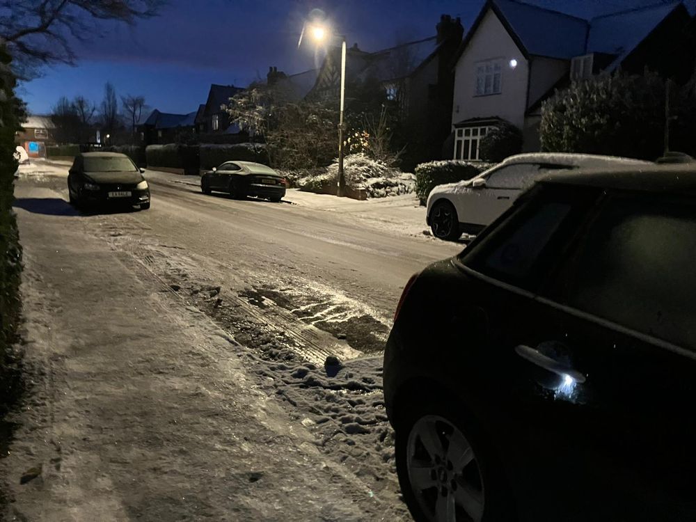 Mrs B took this photo of her car parked on our road. Compressed frozen snow covering the road and pavements. 