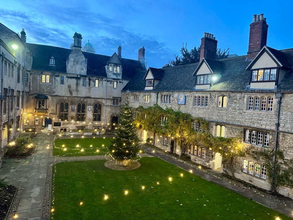 Photo of the front quad of St Edmund Hall with Christmas tree and lights 