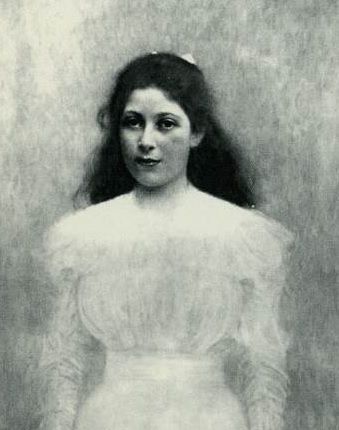 dark-haired girl in ghostly white dress engages the viewer with her direct gaze 