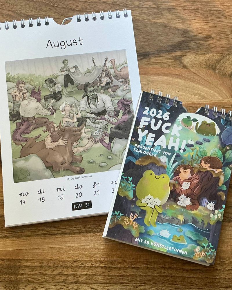Photo of two calendars: A5 version with my illustration (August, cw 34), A6 version with the calendar's cover, which shows a very cute frog, holding tiny hedgehogs.