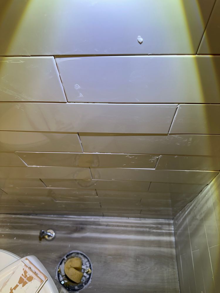 Photo of one of the worst subway tile installations with tiles that are not even and stick out where they shouldn’t