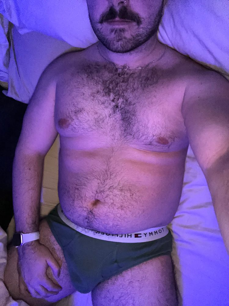 selfie from my nose down to my thighs of me laying in bed wearing green briefs  
