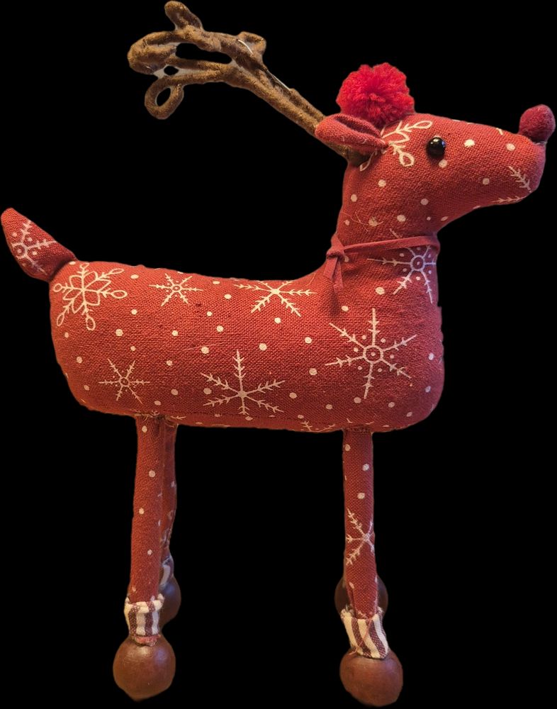 A festive deer doll that was used as a reference for the drawing to the left.