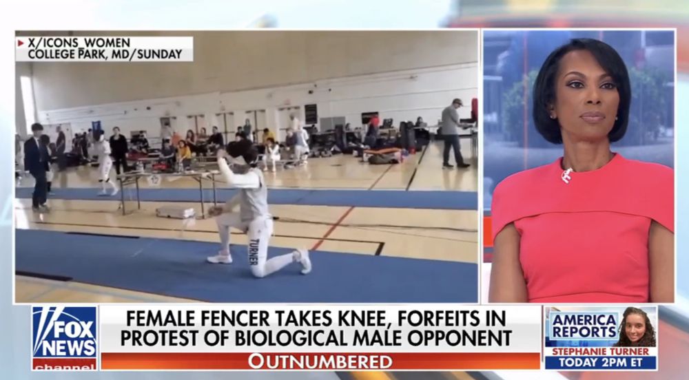A Fox News broadcast features a split screen. On the left, a video shows a fencer kneeling on the piste in a gym during a fencing event in College Park, MD. The text above the video reads, "X/ICONS WOMEN, COLLEGE PARK, MD/SUNDAY." On the right, a female anchor in a bright pink dress looks on seriously. The headline at the bottom says, "FEMALE FENCER TAKES KNEE, FORFEITS IN PROTEST OF BIOLOGICAL MALE OPPONENT." The program is identified as "Outnumbered," with a banner promoting “America Reports” and “Stephanie Turner” airing at 2 PM ET.
