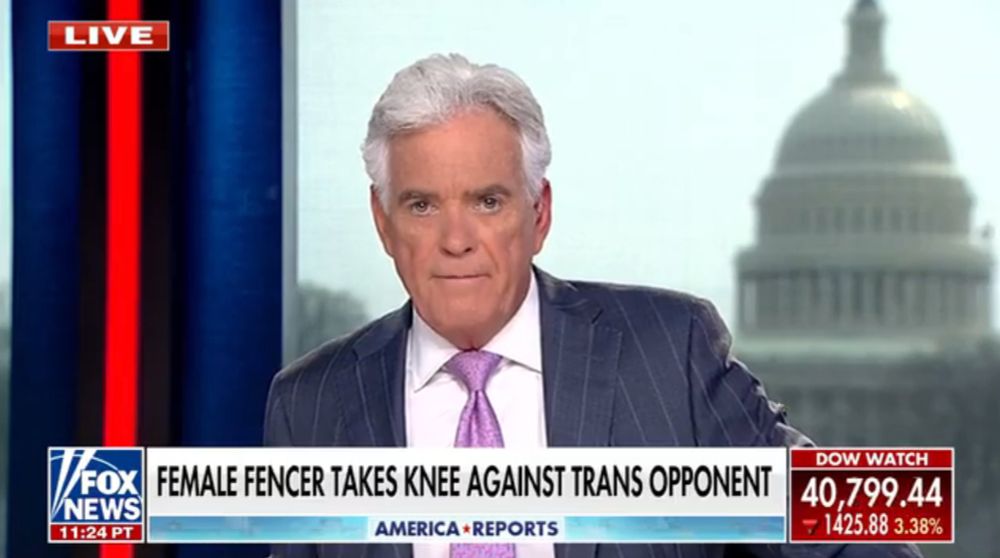 A Fox News broadcast shows a male anchor in a dark pinstripe suit and pink tie reporting live. The headline at the bottom of the screen reads, "FEMALE FENCER TAKES KNEE AGAINST TRANS OPPONENT." The U.S. Capitol building is visible through the window behind him. A red ticker on the bottom right displays the Dow Watch, showing a drop of 1,425.88 points or 3.38%, bringing the total to 40,799.44. The time reads 11:24 PT.
