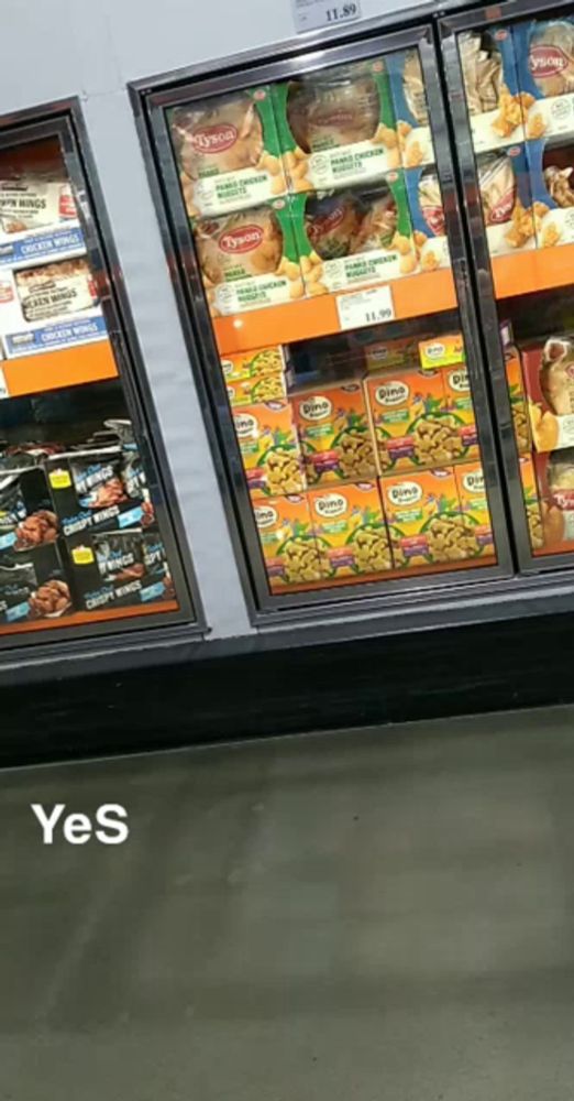 a fridge in a store with a sign that says yes on it