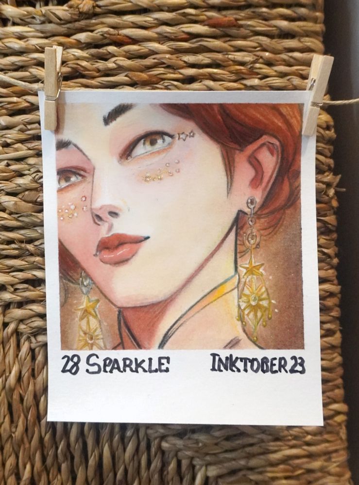 The face of a woman withe large earrings and glitter on her cheeks