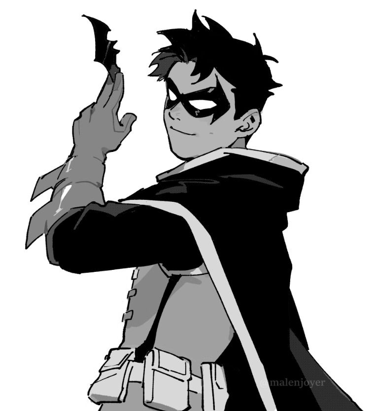 Damian Wayne, robin, body facing left, head facing viewer, arm is at close to a 90 degree angle holding a batarang. He is smiling 