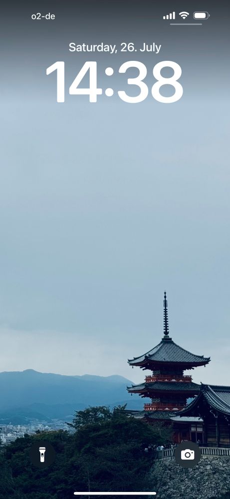 Screenshot of my current Lock Screen. A Japanese pagoda as a background image with mountains in the background 