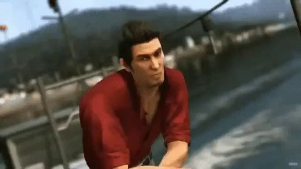 a man in a red shirt is sitting on top of a boat in the water .