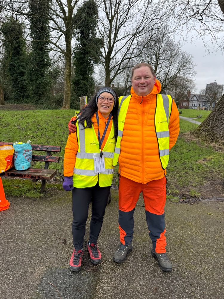 Me and my lovely wife in his-vis volunteering tabards over our apricot parkrun puffer jackets! 