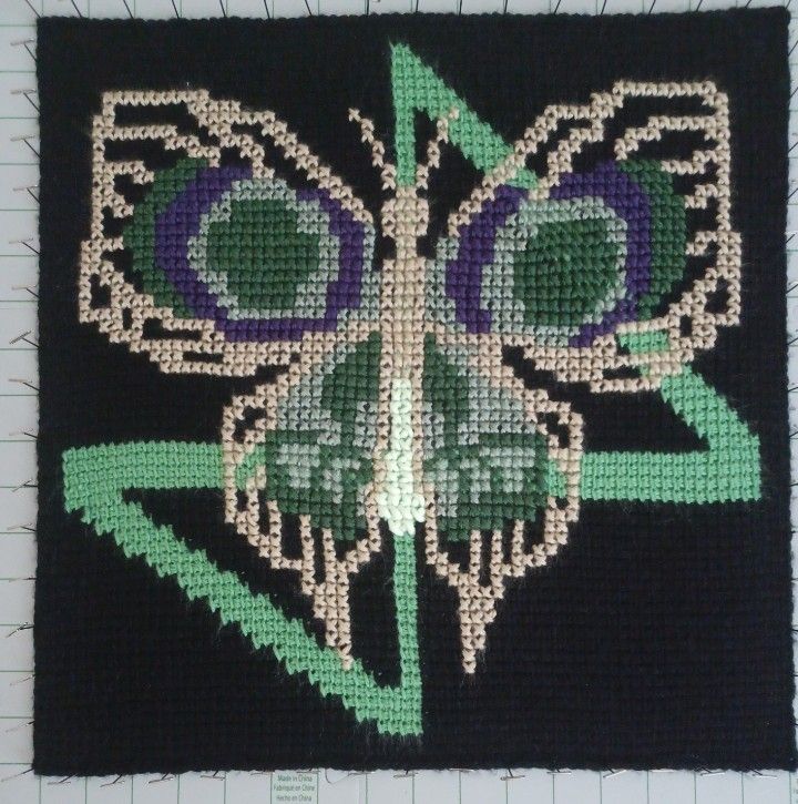 Tunisian crochet square of the firelight symbol and jinx's firelight bomb over it 