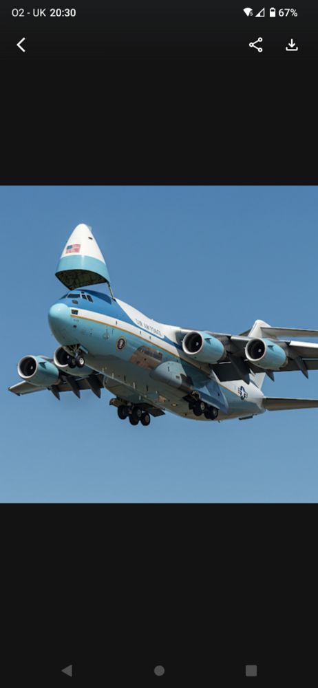 A C-17 in Air Force One livery with the nose cone of a Boeing 747 on top of it's cabin.
