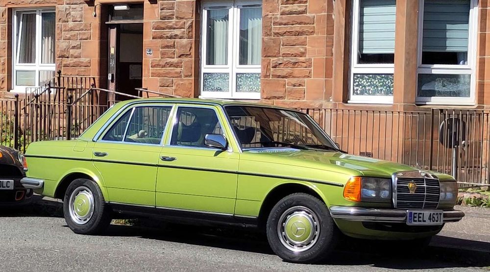 A lemon green Mercedes  car, 1979, with the same colour for it's hub caps and a darker green interior.