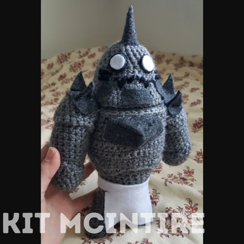 A crochet plush inspired by Alphonse from Full Metal Alchemist.