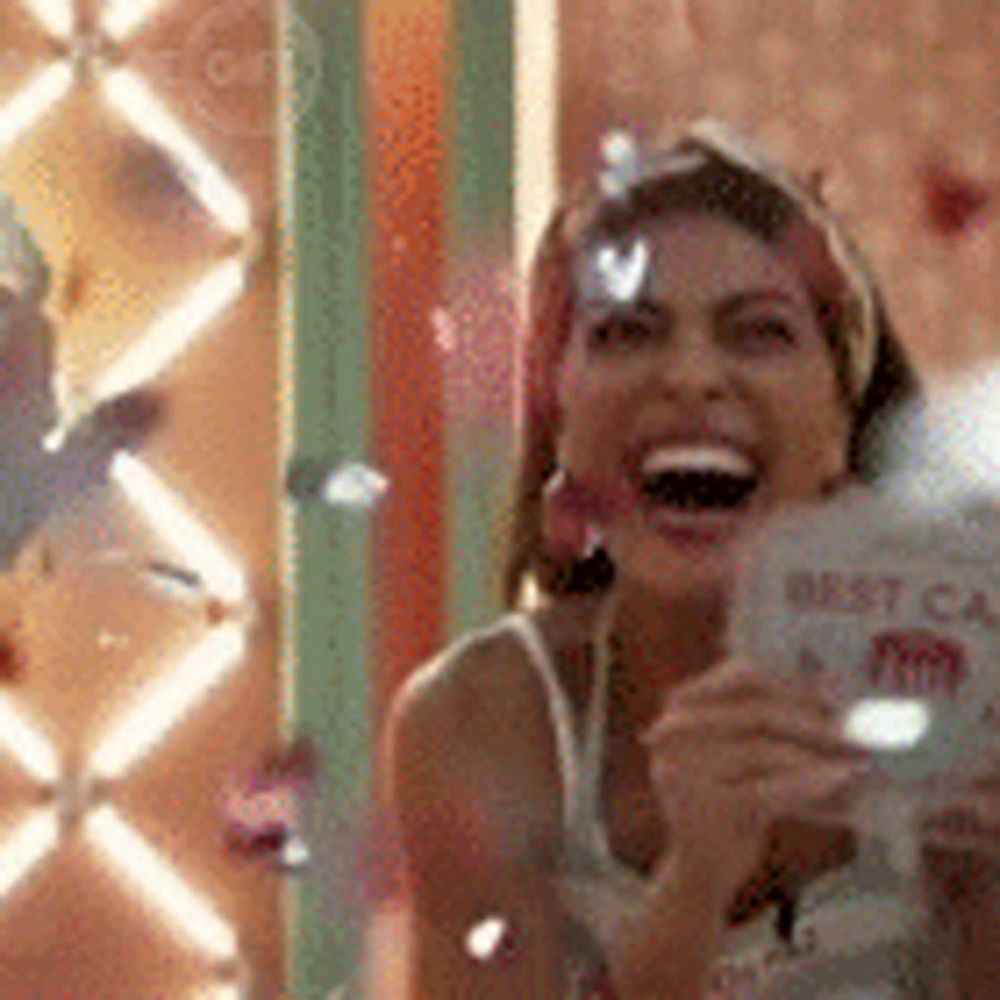 a woman is laughing and holding a book that says best cafe